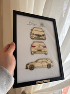 Framed artwork of a car model with 'Bentley' branding held by a person.